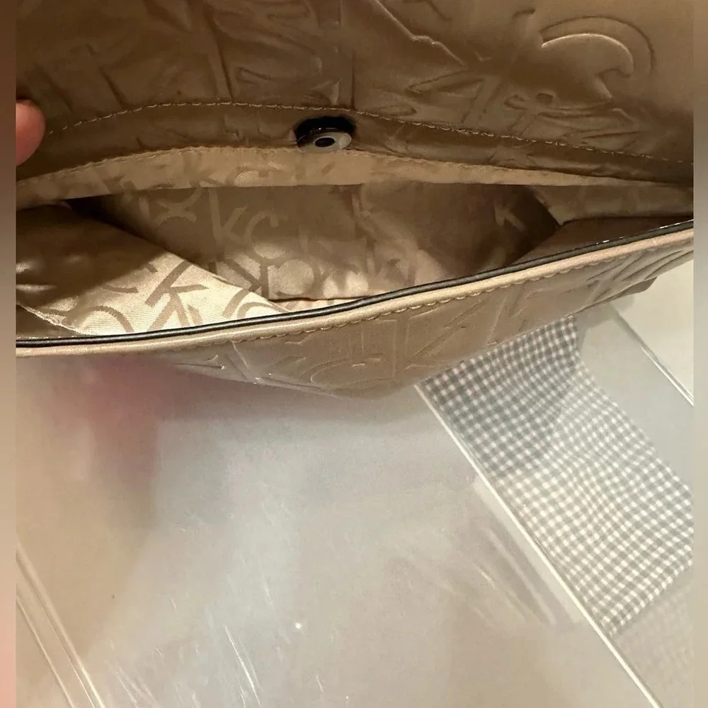 Calvin Klein logo purse. Leather and chain strap. Taupe color, 3 compartments